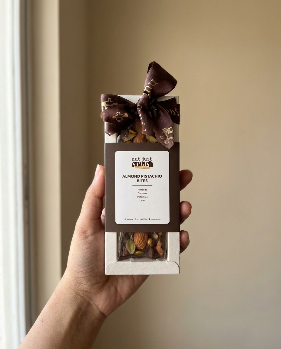Almond Pistachio Bites box of 3 held in one hand