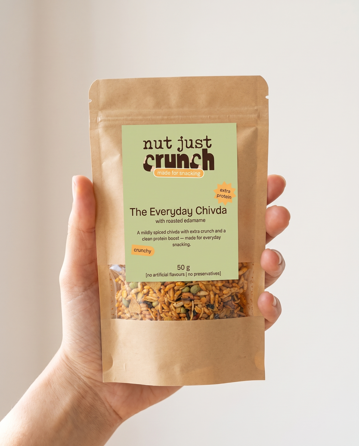 A single 50 g Edamame Chivda pouch held in one hand